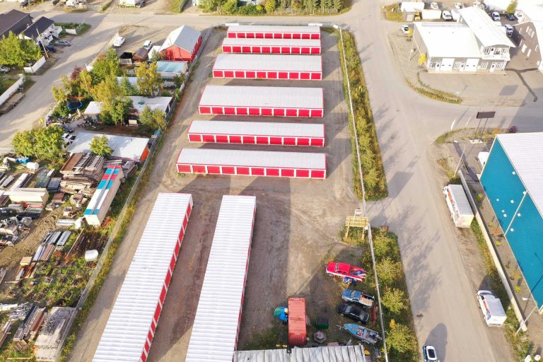Rows of white buildings with red doors